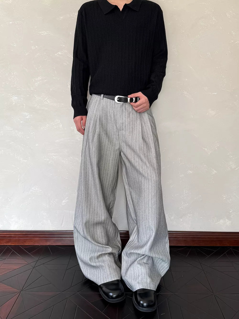 Relaxed wide-leg sweatpants in light grey with vertical pinstripes and a comfortable fit.