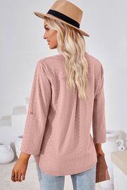 Textured blush pink henley shirt with roll-tab sleeves and a relaxed fit.