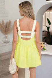 Yellow gingham layered mini dress with back cutouts and ruffled straps.