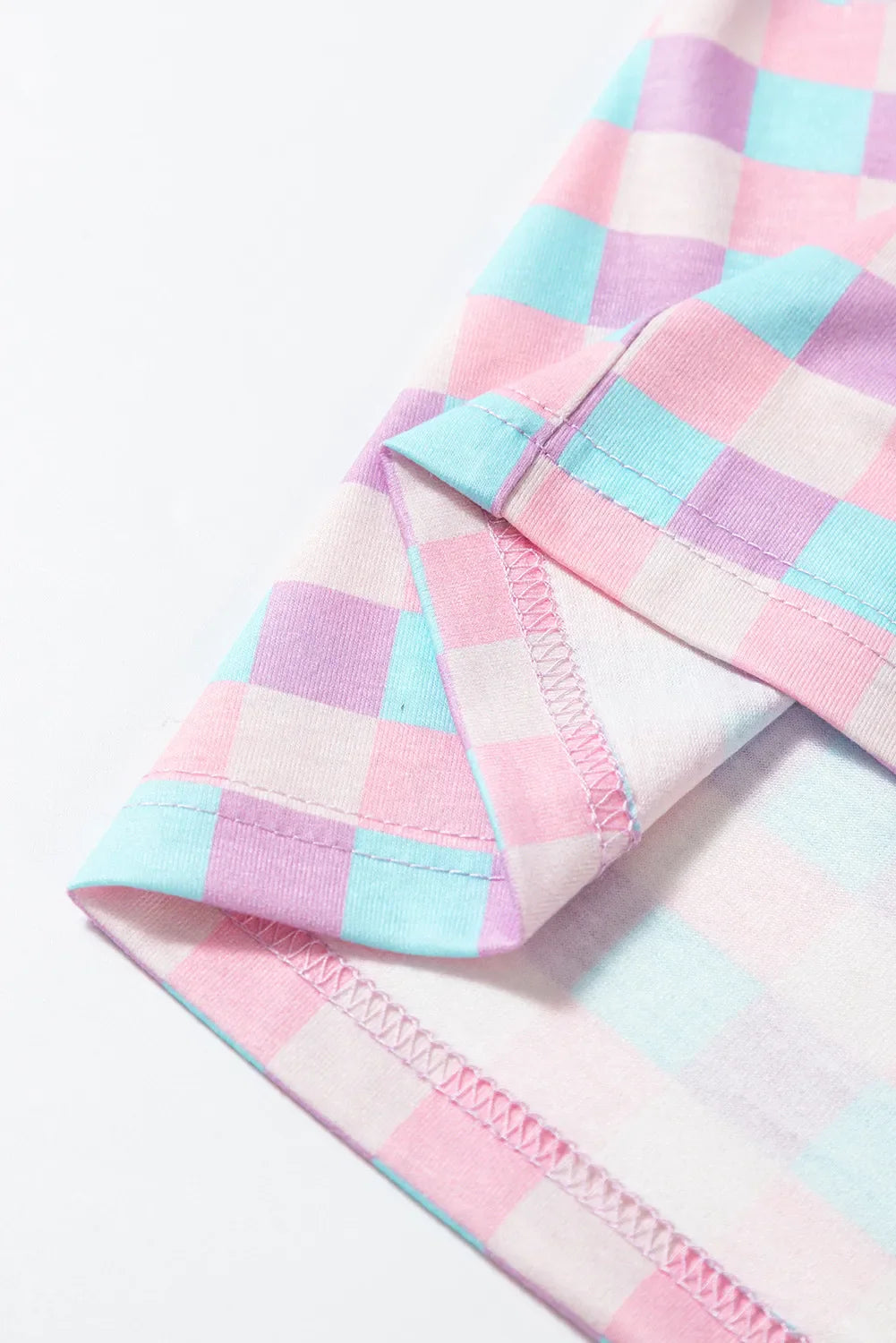 Pastel checkered pajama set detail showing hem and stitching