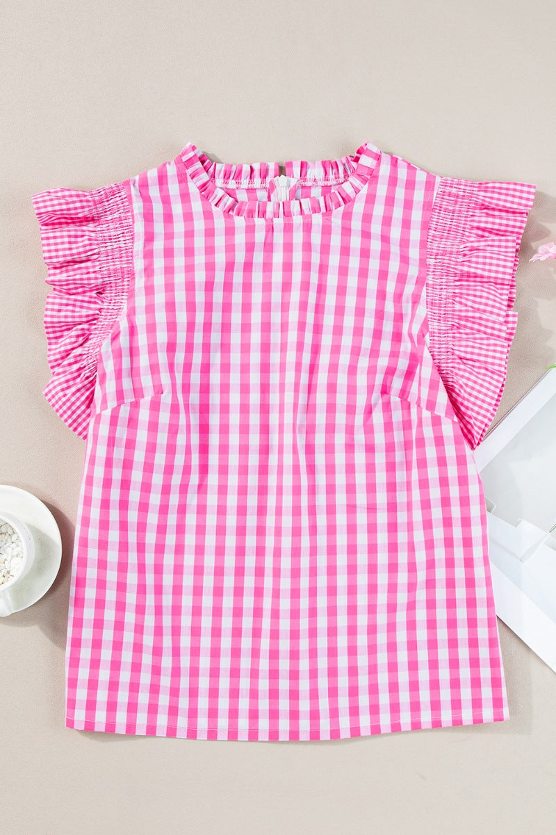 Fuchsia pink gingham blouse with ruffled neckline and flutter sleeves.