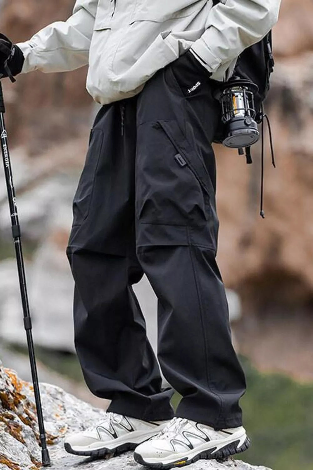 Black lightweight quick-dry cargo pants with multiple pockets and a drawstring waist.