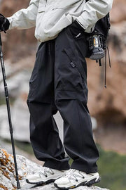 Black lightweight quick-dry cargo pants with multiple pockets and a drawstring waist.