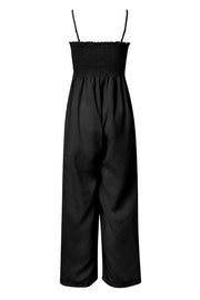 Black smocked bodice palazzo jumpsuit with adjustable spaghetti straps and wide legs.