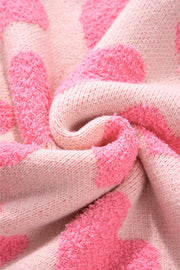 Textured heart motif knit sweater in blush pink with fluffy yarn details.