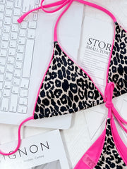 Leopard print tie-side bikini top with hot pink trim and ties.
