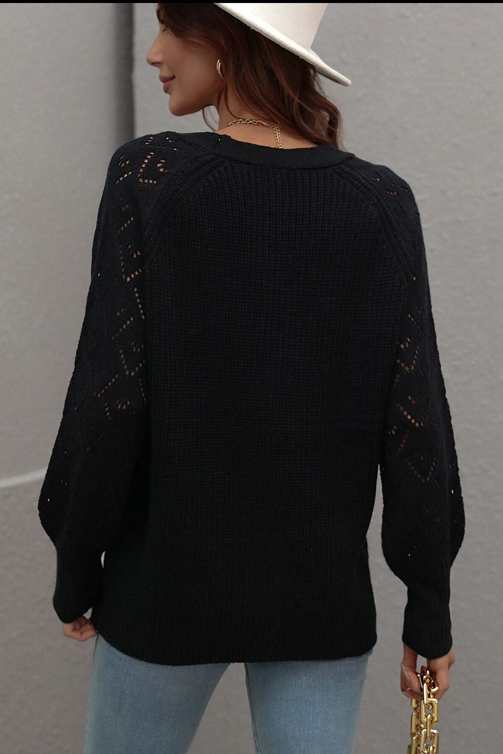 Black diamond knit cardigan with openwork sleeves and crew neck.