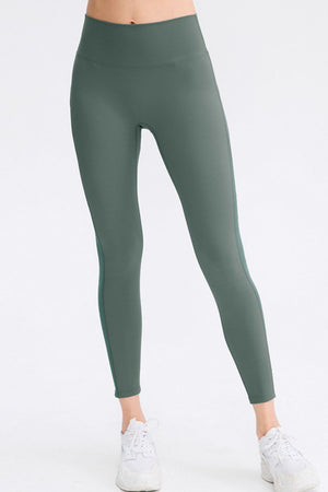 Matcha green performance leggings with subtle side panel detail.