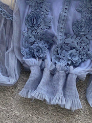 Blue lace blouse with floral embroidery and ruffled mesh sleeves.