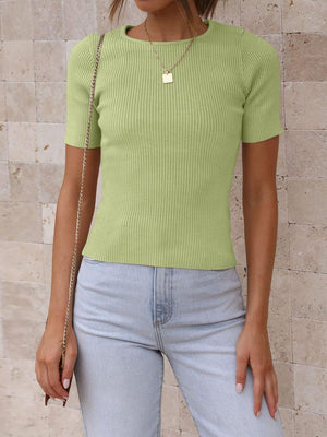 Lime green ribbed knit t-shirt with short sleeves and a crew neck, styled with light wash jeans.