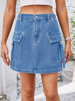 Denim cargo skirt in Dusty Blue with utility pockets and metal ring details.