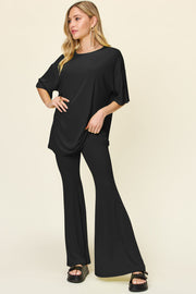 Black oversized tee and flare leg pants set with short sleeves and a crew neck.