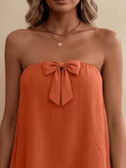 Orange strapless tube top with a large bow detail.