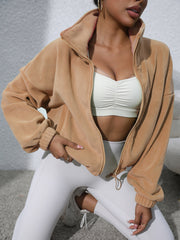 Tan fleece cropped funnel neck jacket with full zip and cuffed sleeves.