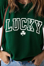 Dark green t-shirt with white LUCKY graphic and shamrock detail, rolled sleeves.