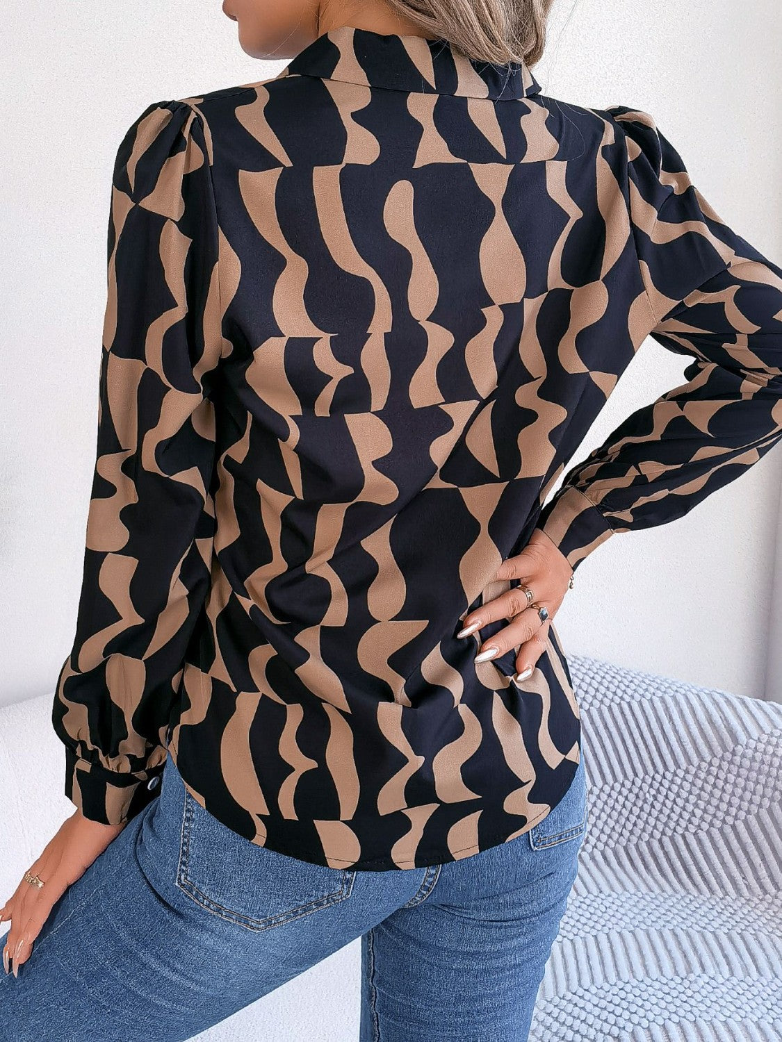 Black and camel abstract wave print silk-touch blouse with puff sleeves.