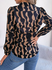 Black and camel abstract wave print silk-touch blouse with puff sleeves.
