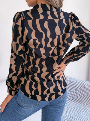 Black and camel abstract wave print silk-touch blouse with puff sleeves.