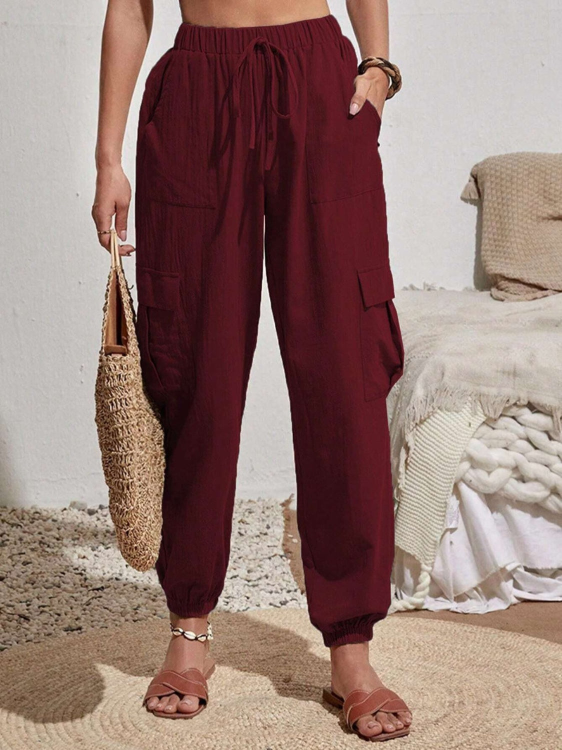 Burgundy textured cargo lounge trousers with drawstring waist and cuffed ankles.