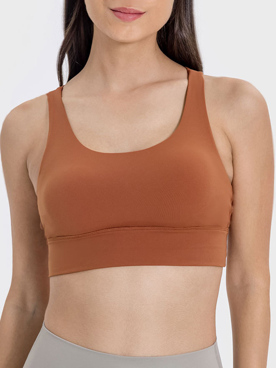 Caramel performance bra with scoop neck and crisscross back detail.