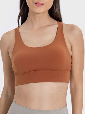 Caramel performance bra with scoop neck and crisscross back detail.