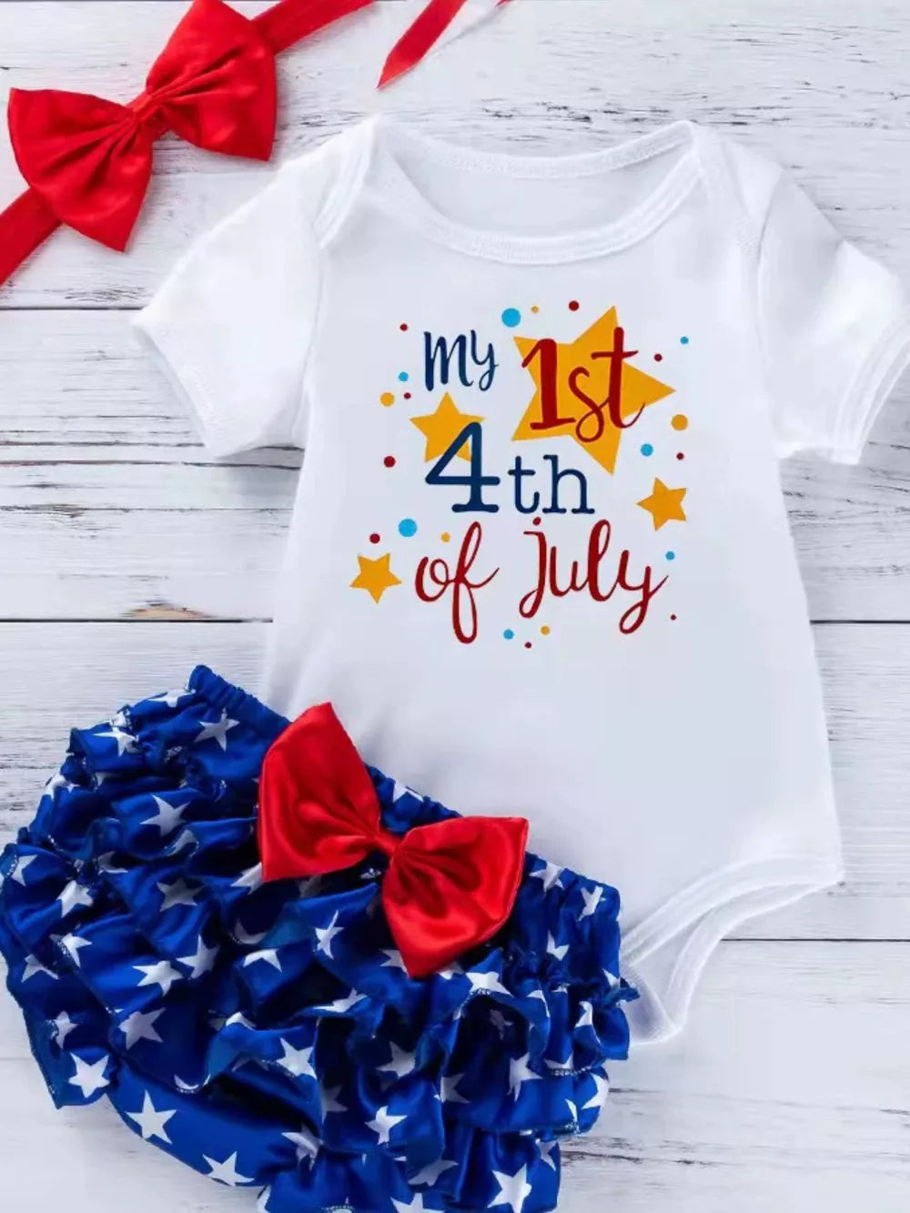 White baby onesie with 1st 4th of July graphic and ruffled star bloomer with red bow.