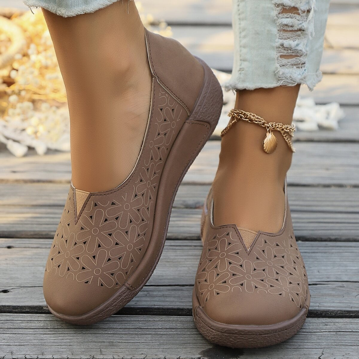 Brown floral cutout slip-on loafers with breathable design.