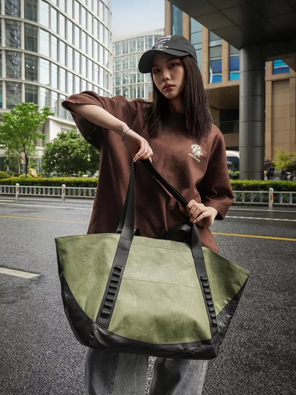 Green and black two-tone large capacity travel bag with black straps and black base detail.