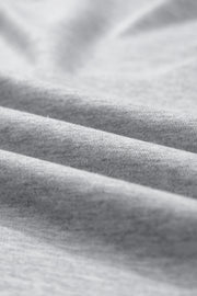 Gray sweatshirt fabric detail showing soft texture and folds.