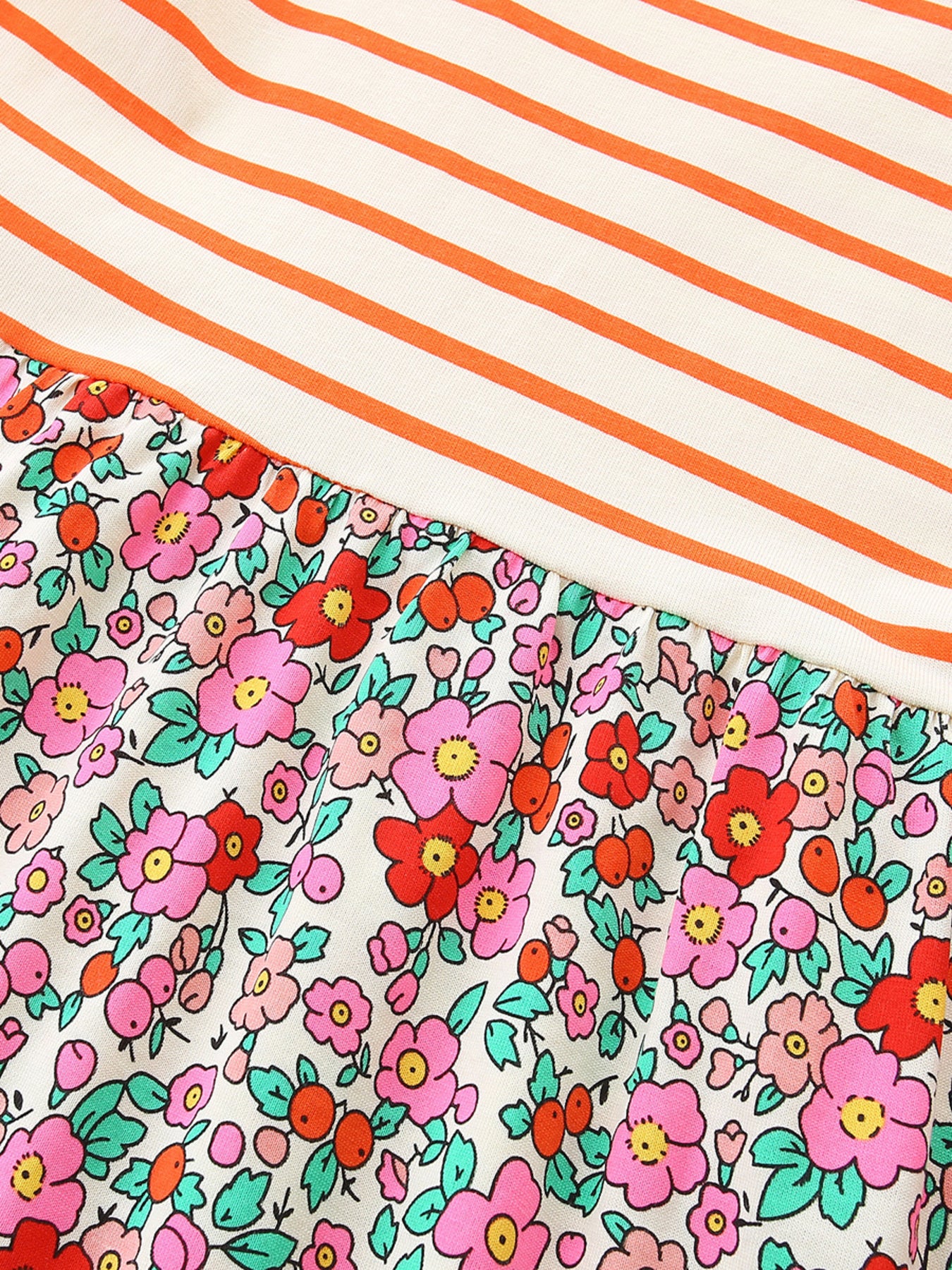 Baby dress with orange stripes and a floral print skirt