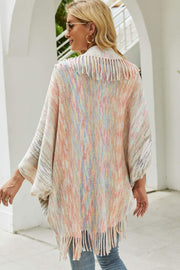 Textured stripe fringe cape with pastel multicolor yarn and fringe detail.