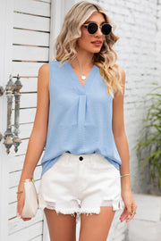 Light blue textured sleeveless blouse with V-neck and front pleats.