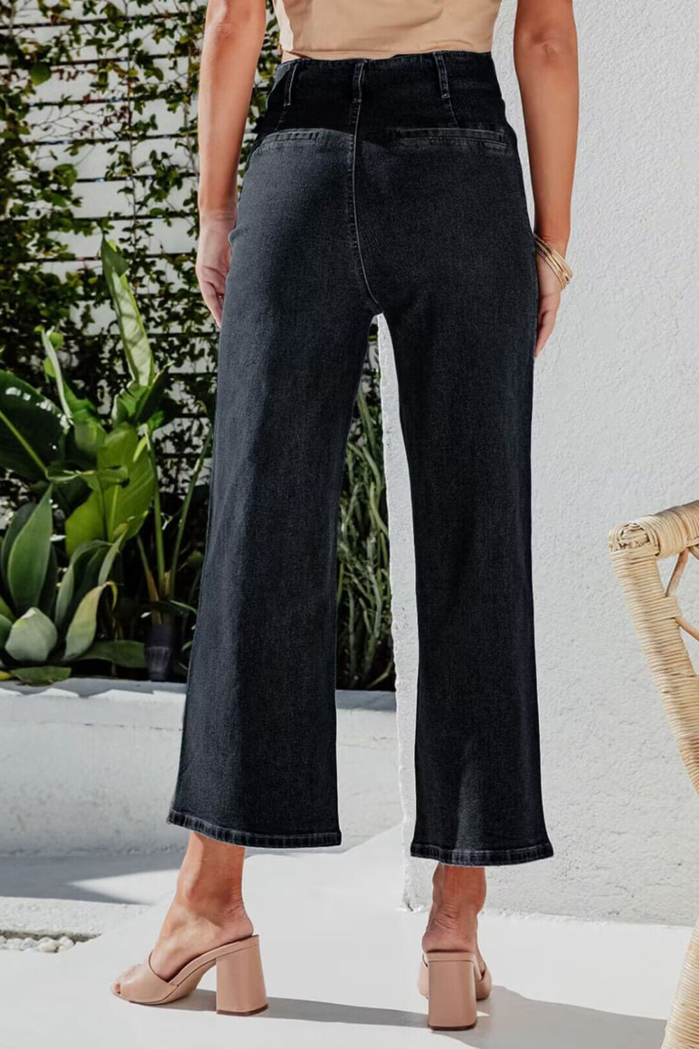 Black button-front cropped wide-leg jeans with a high waist.