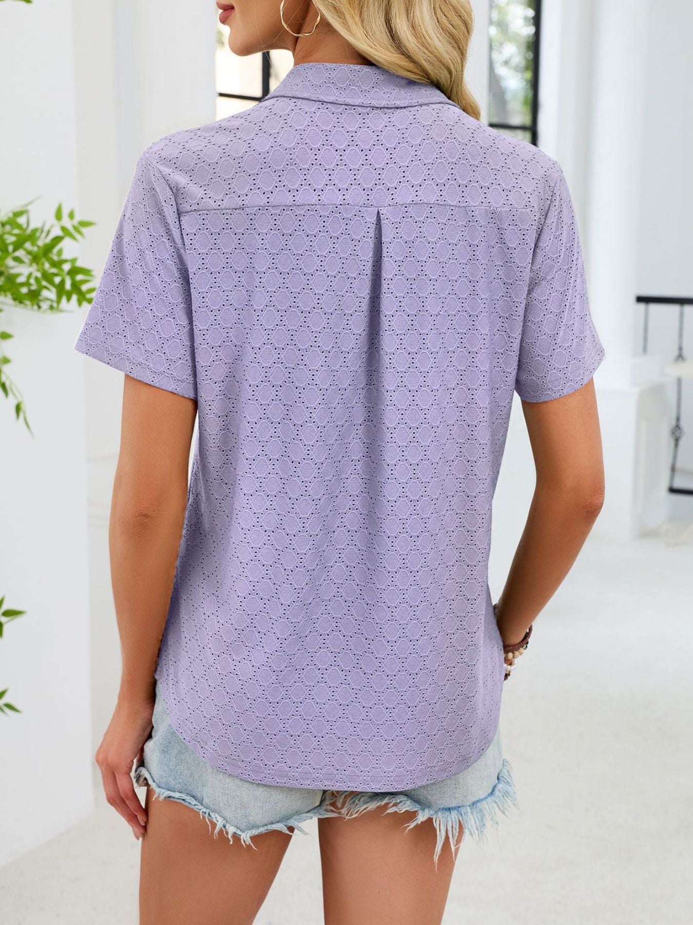 Lavender eyelet polo collar blouse with short sleeves and a back pleat detail.