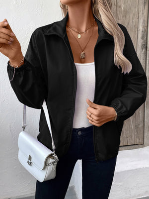 Black nylon bomber jacket with zippered front and elastic drawstring hem.