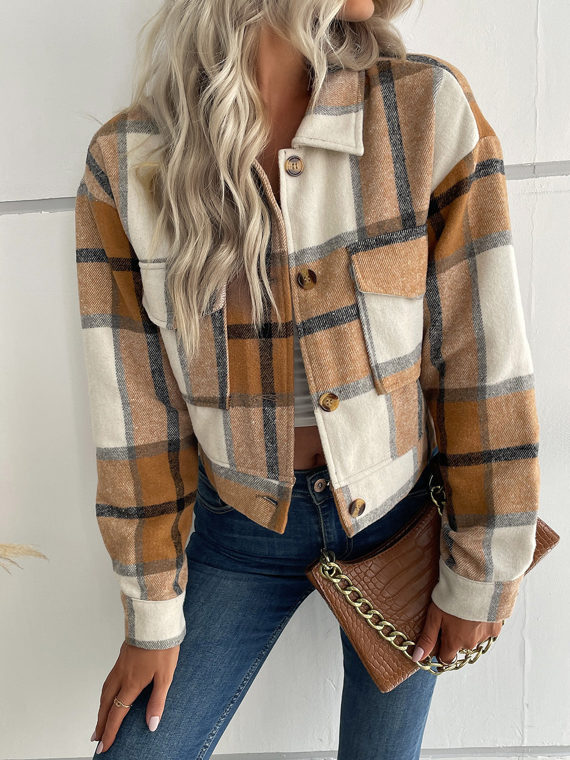 Checked plaid shacket with patch pockets in brown, cream, and black. Button front, collared, long sleeve.