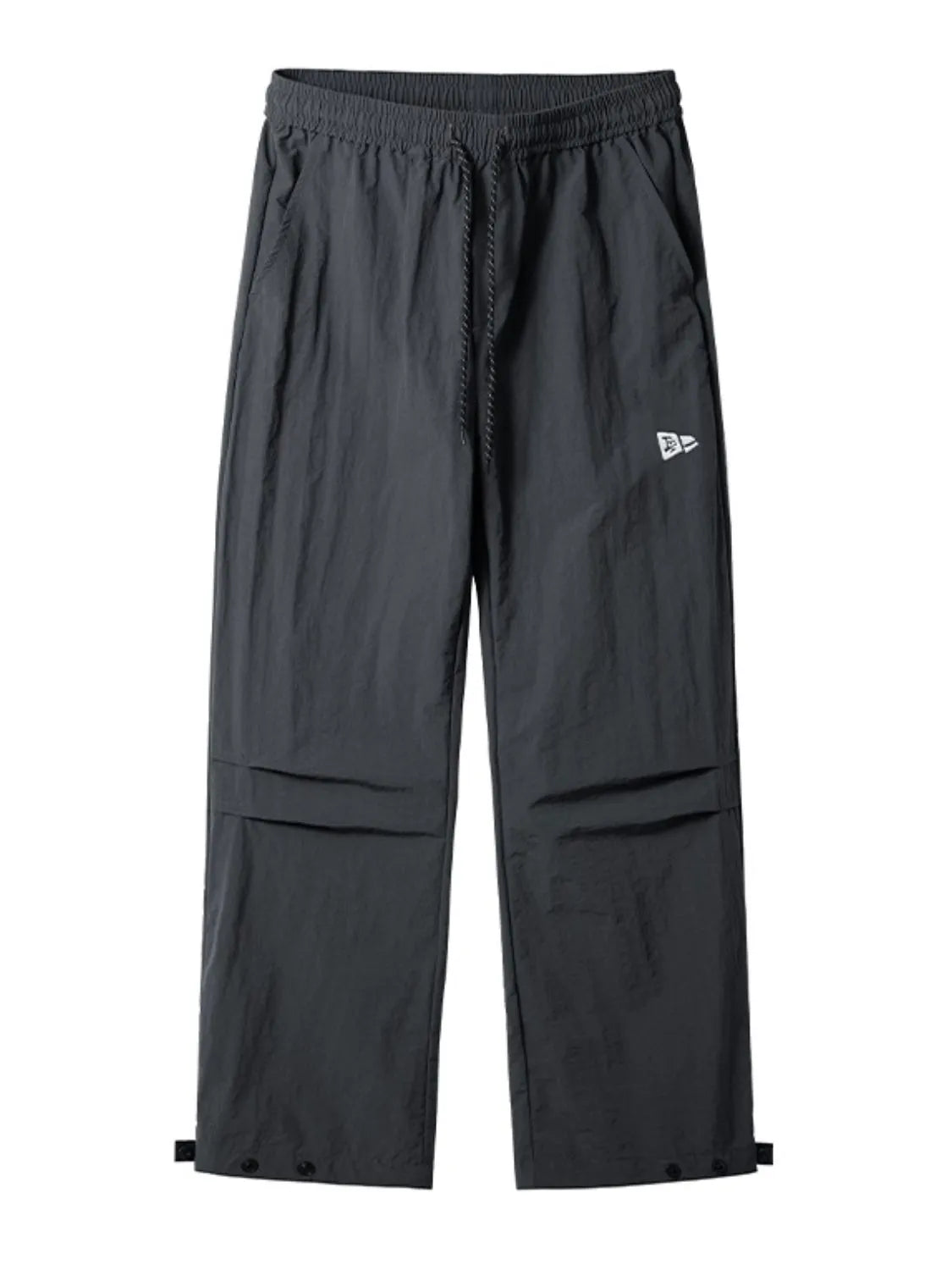 Dark gray utility joggers with relaxed fit, drawstring waist, cargo pockets, and adjustable ankle snaps.