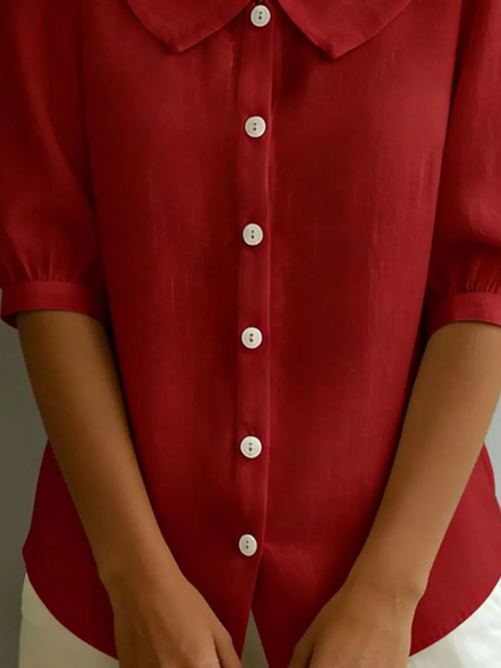 Deep Red puff sleeve shirt with Peter Pan collar and white buttons.