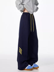 Dark Navy relaxed fit sweatpants with yellow drawstring and stripe detail.