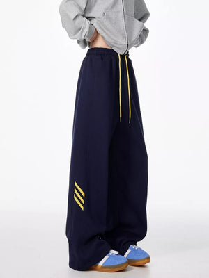 Dark Navy relaxed fit sweatpants with yellow drawstring and stripe detail.