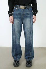 Medium wash denim wide leg jeans with vertical seams and a relaxed fit.