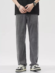 Relaxed fit wide-leg denim trousers in dark gray, styled casually.
