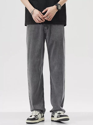 Relaxed fit wide-leg denim trousers in dark gray, styled casually.