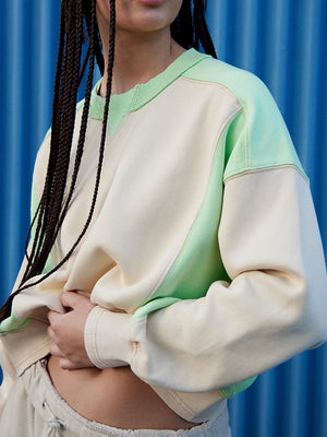Cream and gum leaf colorblock sweatshirt with contrast stitching and crew neck.