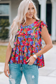 Tiered multicolor floral print blouse with flutter sleeves and scoop neck.