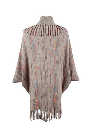 Textured knit cape in Khaki with multicolor stripes and fringe trim.