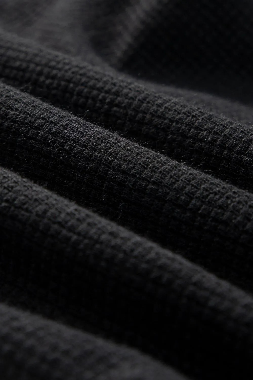 Black waffle knit jumpsuit detail showing texture