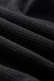 Black waffle knit jumpsuit detail showing texture