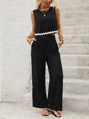 Black scalloped trim crop top and wide leg pants set with white trim detail.