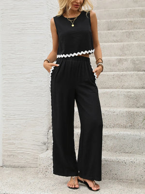 Black scalloped trim crop top and wide leg pants set with white trim detail.